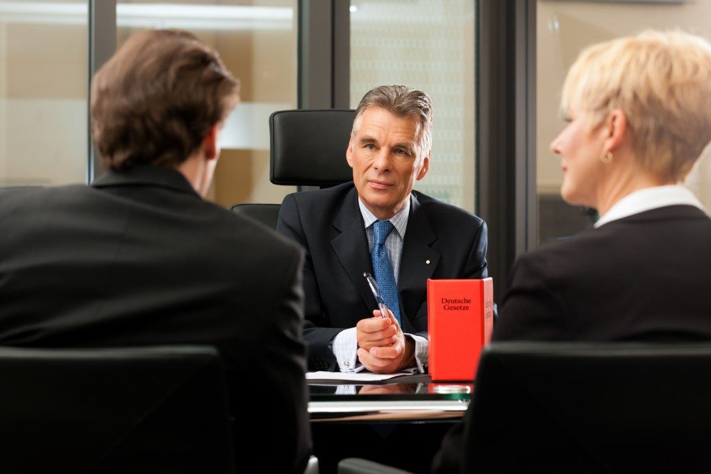 lawyer in a meeting with his clients